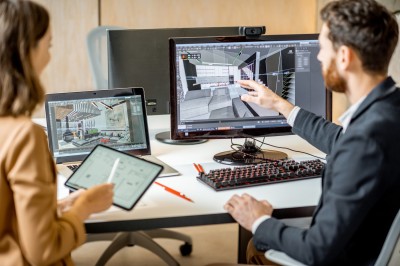 A man and woman looking at a computer